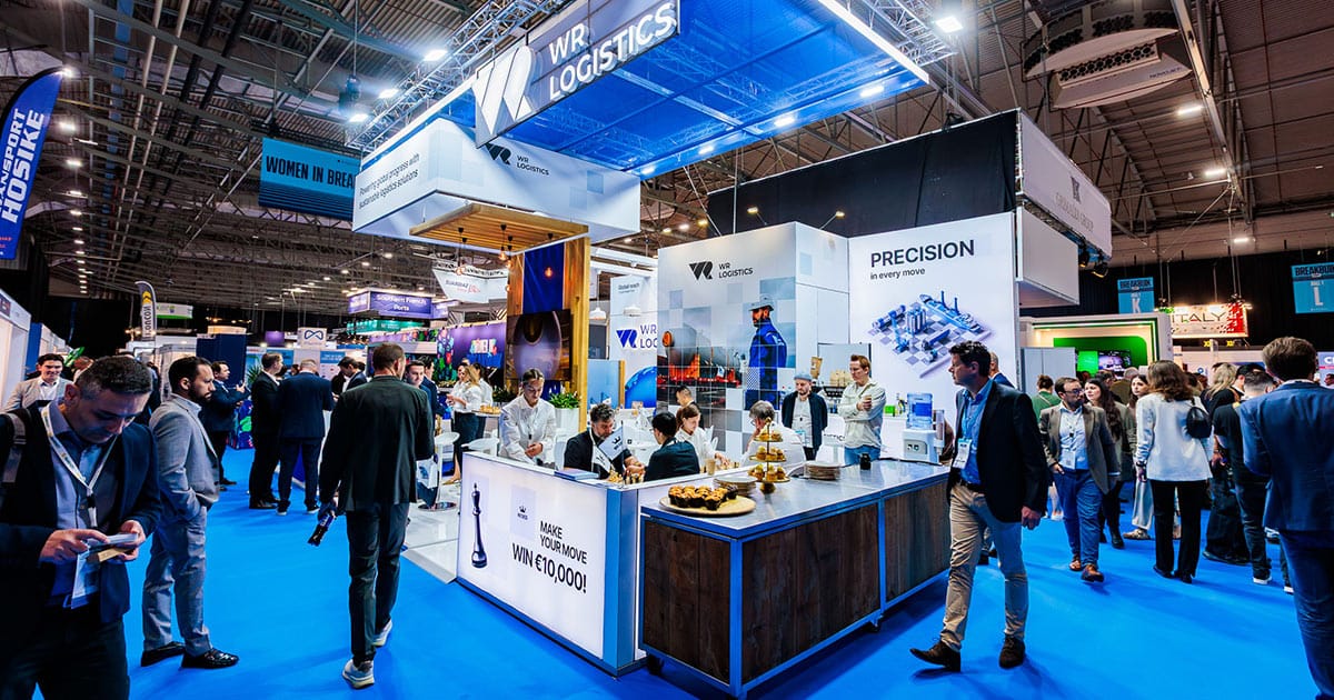 WR Logistics booth at Breakbulk Europe 2025 featuring the chess challenge and branding